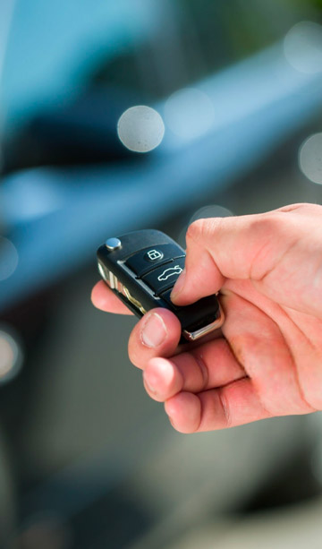 A person unlocking their car