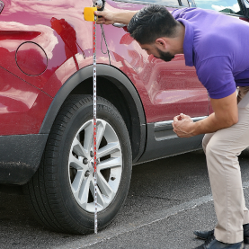 A person looking at his new car