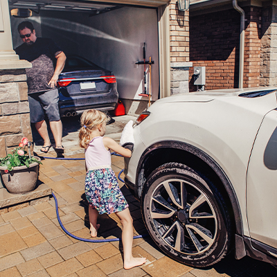 Father and child next to their two cars